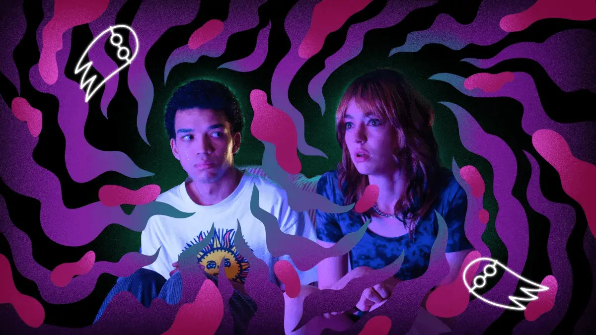 A24's I Saw the TV Glow shows main characters Owen and Maddy watching tv while surrounded by pink swirls and ghosts. 