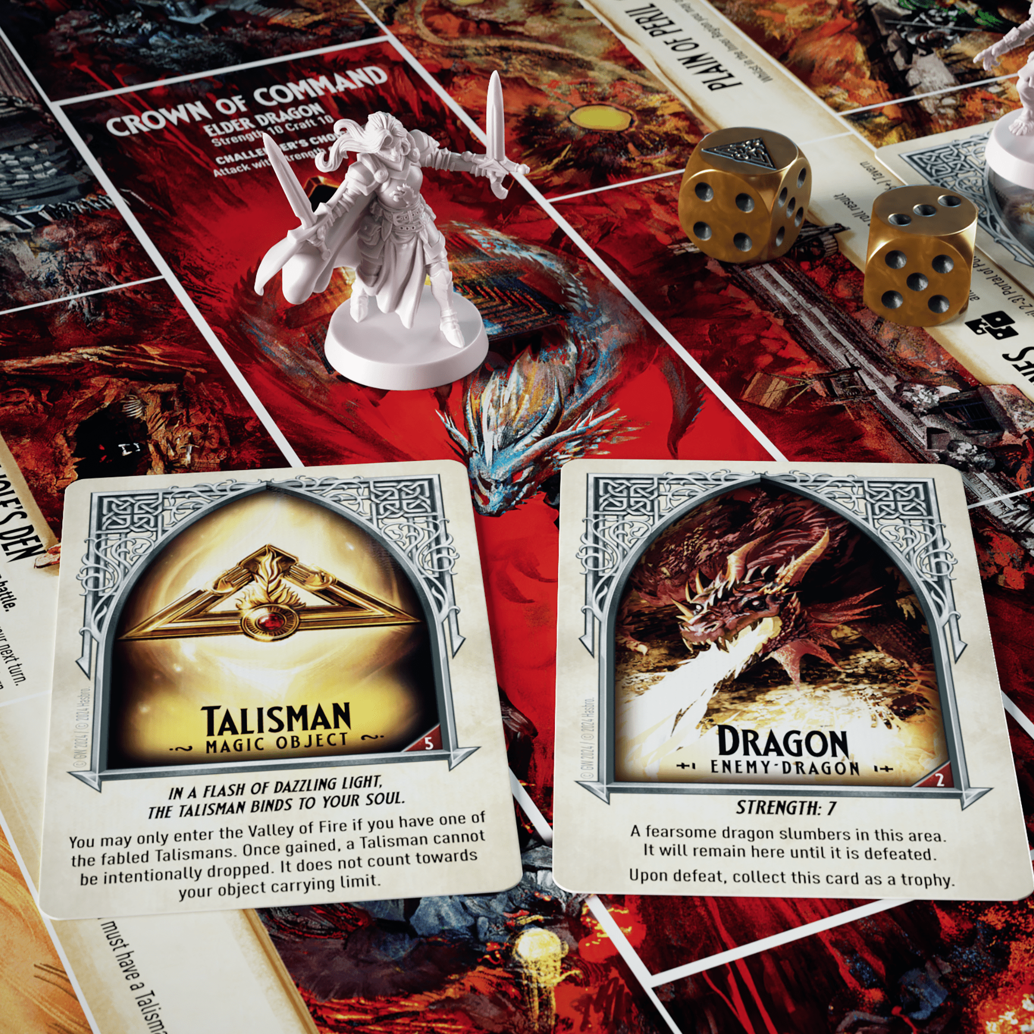 a talisman card, and a dragon card in front of a figure