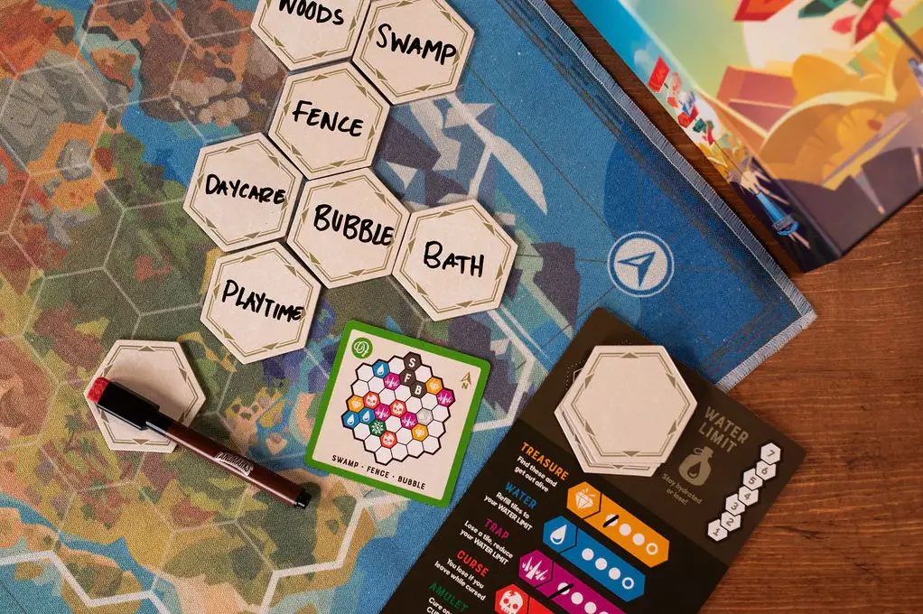 seven tiles with words on the landmarks map next to the map card and tracker card 