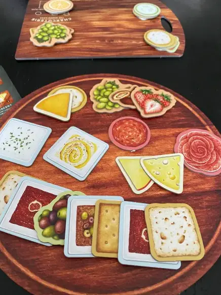 charcuterie tiles on a player board in front of the serving board