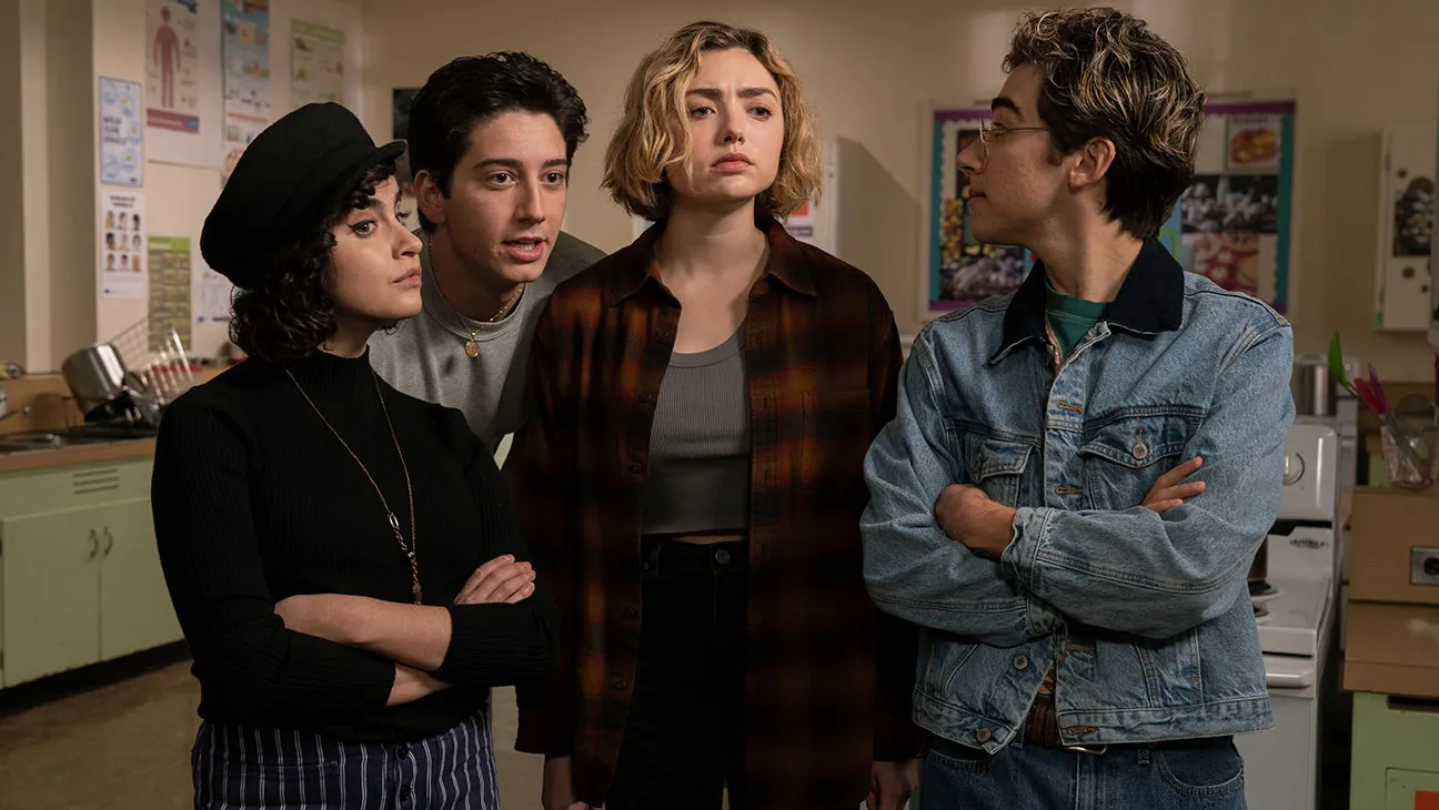 Peyton List, Milo Manheim, Sarah Yarkin and Nick Pugliese stand together in a classroom. 